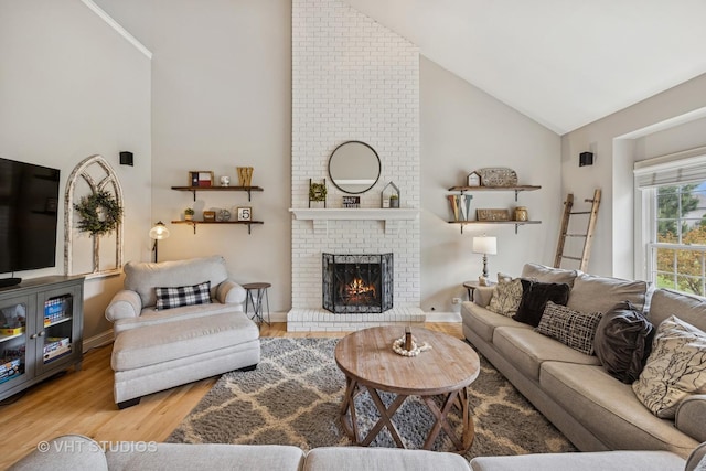 651 Clover Dr, Algonquin, IL 60102 - living area with high vaulted ceiling, wood finished floors, a fireplace, and baseboards