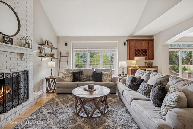 651 Clover Dr, Algonquin, IL 60102 - living area featuring a fireplace, light wood-style flooring, and high vaulted ceiling