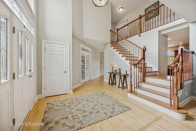 651 Clover Dr, Algonquin, IL 60102 - entryway featuring wood finished floors, a high ceiling, stairs, and baseboards