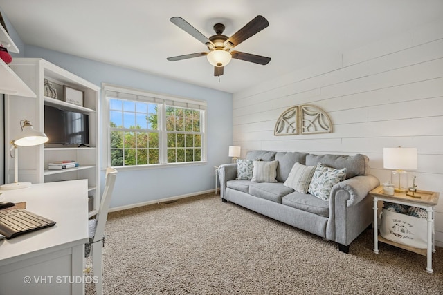651 Clover Dr, Algonquin, IL 60102 - living room featuring a ceiling fan, carpet, wooden walls, and baseboards