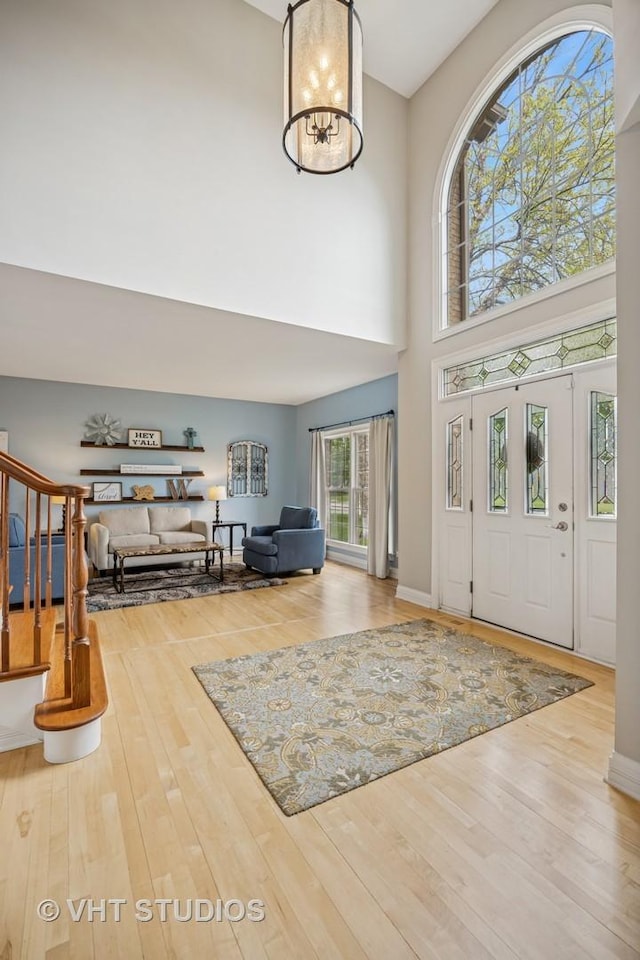 651 Clover Dr, Algonquin, IL 60102 - entryway featuring a towering ceiling, wood finished floors, and stairs
