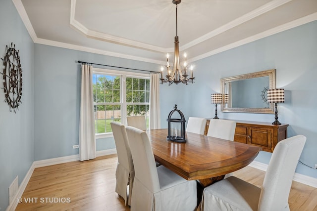 651 Clover Dr, Algonquin, IL 60102 - dining room with a chandelier, light wood-type flooring, a tray ceiling, baseboards, and ornamental molding