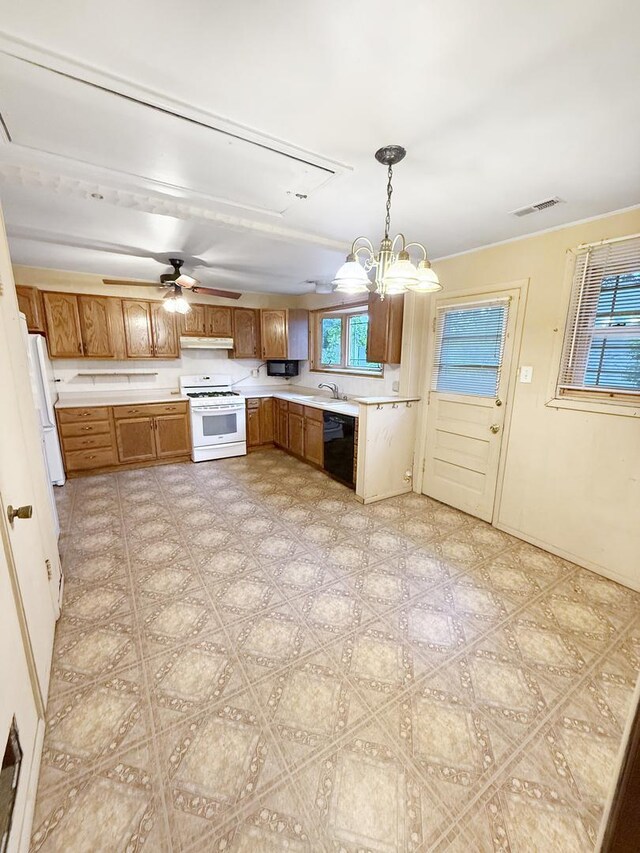 942 W Villa Dr, Des Plaines, IL 60016 - kitchen with white appliances, under cabinet range hood, light countertops, a sink, and brown cabinets