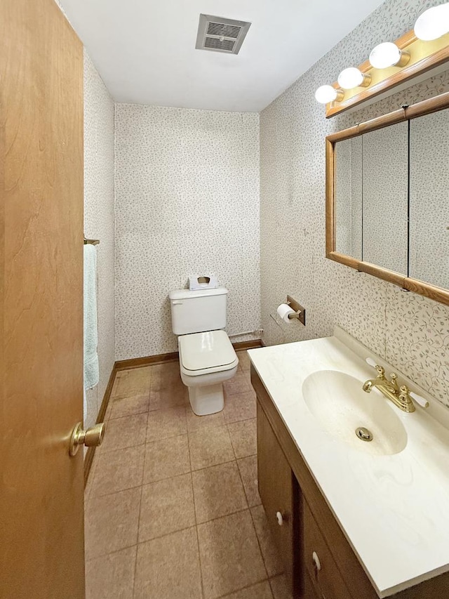 942 W Villa Dr, Des Plaines, IL 60016 - bathroom featuring wallpapered walls, vanity, toilet, and tile patterned flooring