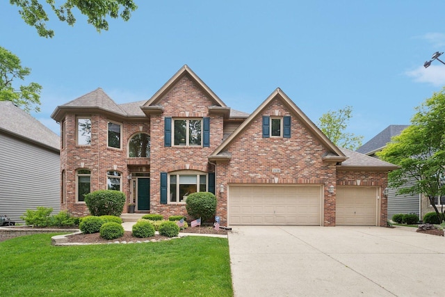 2156 Red Maple Ln, Aurora, IL 60502 - view of front of house featuring a front lawn, driveway, brick siding, and an attached garage