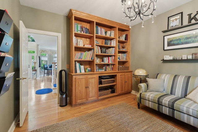 2156 Red Maple Ln, Aurora, IL 60502 - living area featuring light wood-type flooring, a chandelier, and baseboards