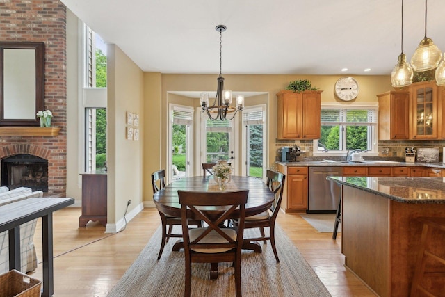 2156 Red Maple Ln, Aurora, IL 60502 - dining room featuring a chandelier, light wood finished floors, a brick fireplace, baseboards, and recessed lighting