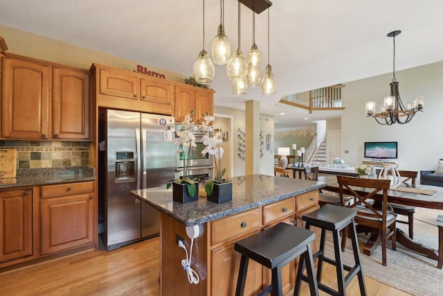 2156 Red Maple Ln, Aurora, IL 60502 - kitchen featuring stainless steel fridge with ice dispenser, a chandelier, light wood finished floors, a breakfast bar, and a kitchen island