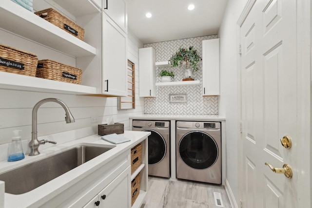 2156 Red Maple Ln, Aurora, IL 60502 - laundry room with washer and dryer, cabinet space, recessed lighting, and light wood-style flooring