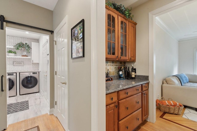 2156 Red Maple Ln, Aurora, IL 60502 - bar area with separate washer and dryer, backsplash, light wood-style floors, and a barn door