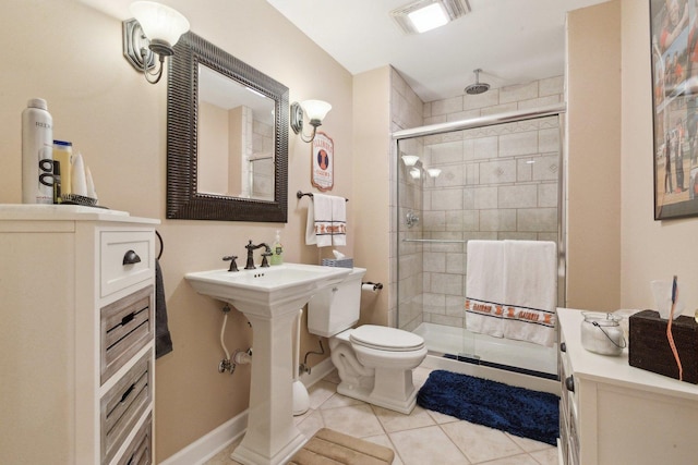 2156 Red Maple Ln, Aurora, IL 60502 - bathroom featuring toilet, a shower stall, tile patterned floors, and baseboards