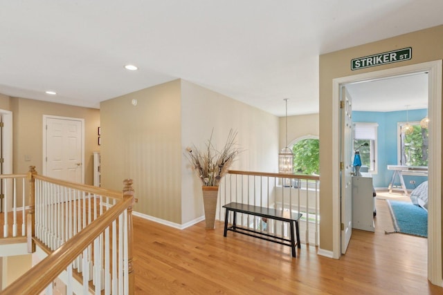 2156 Red Maple Ln, Aurora, IL 60502 - corridor with an upstairs landing, light wood finished floors, baseboards, recessed lighting, and a chandelier