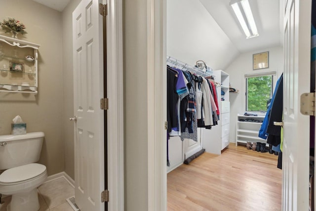 2156 Red Maple Ln, Aurora, IL 60502 - bathroom with lofted ceiling, toilet, wood finished floors, and a spacious closet