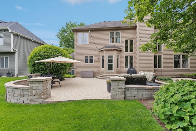 2156 Red Maple Ln, Aurora, IL 60502 - back of property featuring a lawn and a patio area