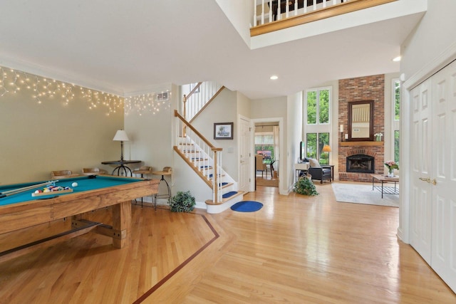 2156 Red Maple Ln, Aurora, IL 60502 - game room featuring a brick fireplace, pool table, wood finished floors, a high ceiling, and recessed lighting