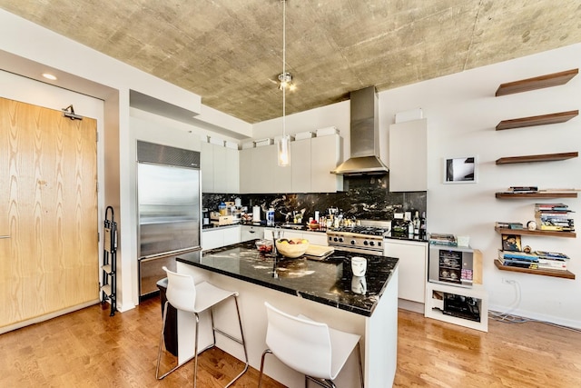 600 N Fairbanks Ct Unit 3306, Chicago, IL 60611 - kitchen with premium appliances, wall chimney range hood, light wood-style flooring, and backsplash