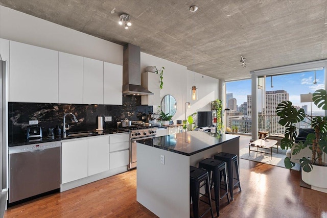 600 N Fairbanks Ct Unit 3306, Chicago, IL 60611 - kitchen with stainless steel appliances, a sink, tasteful backsplash, wall chimney range hood, and a center island