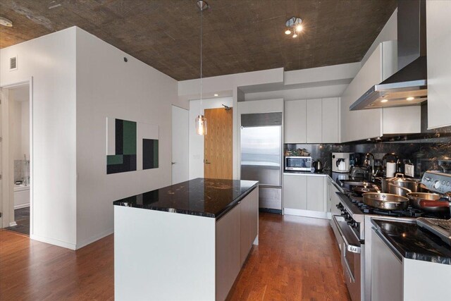 600 N Fairbanks Ct Unit 3306, Chicago, IL 60611 - kitchen with wall chimney range hood, appliances with stainless steel finishes, a kitchen island, white cabinets, and dark wood-type flooring