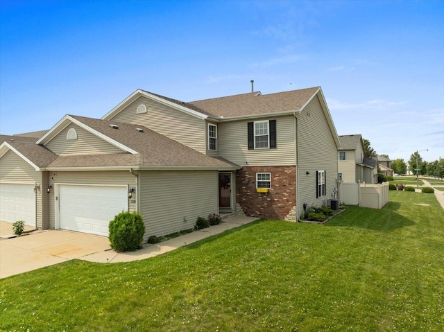 3100 Shepard Rd, Normal, IL 61761 - view of front of property featuring an attached garage, concrete driveway, a front lawn, central AC, and roof with shingles