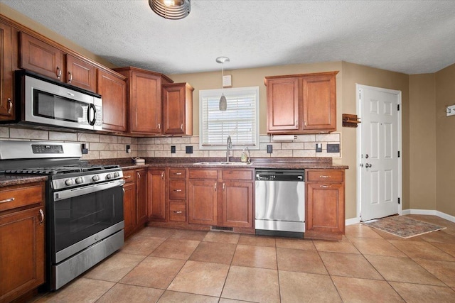 3100 Shepard Rd, Normal, IL 61761 - kitchen featuring appliances with stainless steel finishes, a sink, dark countertops, decorative backsplash, and a textured ceiling