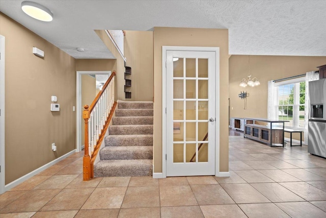 3100 Shepard Rd, Normal, IL 61761 - staircase with a textured ceiling, a chandelier, baseboards, and tile patterned flooring