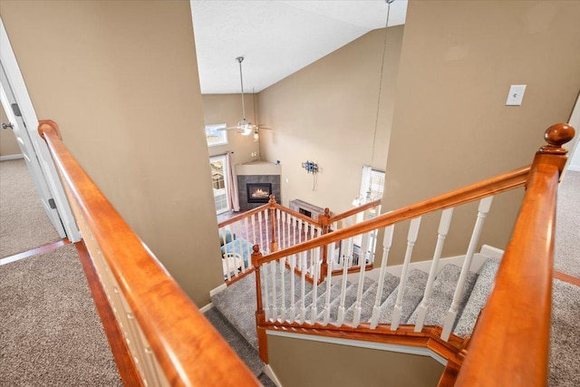 3100 Shepard Rd, Normal, IL 61761 - staircase with carpet flooring, a ceiling fan, a tile fireplace, high vaulted ceiling, and baseboards