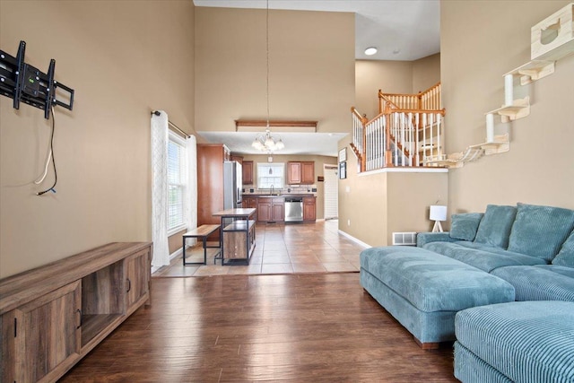 3100 Shepard Rd, Normal, IL 61761 - living room with baseboards, a high ceiling, light wood-style flooring, and stairway