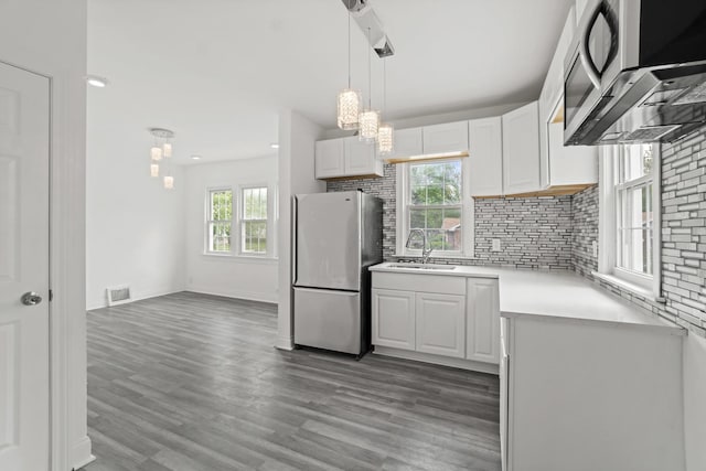 14856 Perry Ave, South Holland, IL 60473 - kitchen with stainless steel appliances, a sink, white cabinetry, light countertops, and wood finished floors