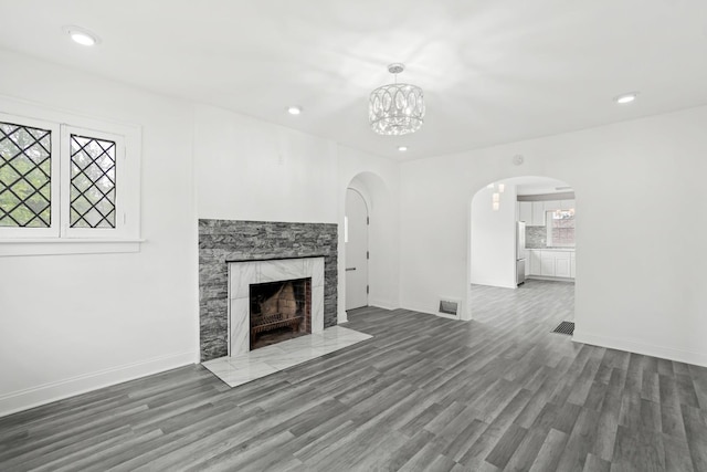 14856 Perry Ave, South Holland, IL 60473 - unfurnished living room with arched walkways, healthy amount of natural light, wood finished floors, and recessed lighting