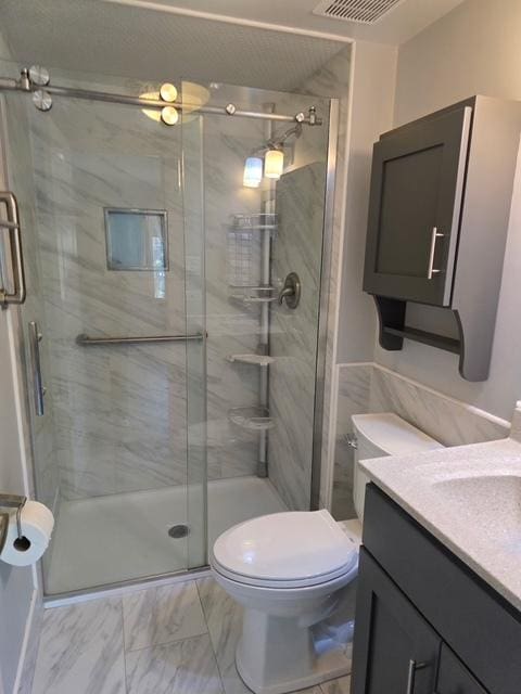 4739 W 105th Pl Unit 101, Oak Lawn, IL 60453 - bathroom featuring vanity, marble look tiles, toilet, and a stall shower