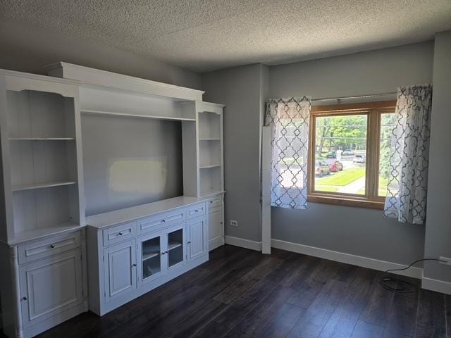 4739 W 105th Pl Unit 101, Oak Lawn, IL 60453 - unfurnished living room with dark wood-style floors, a textured ceiling, and baseboards