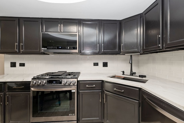 4739 W 105th St Unit 101, Oak Lawn, IL 60453 - kitchen with appliances with stainless steel finishes, a sink, decorative backsplash, light stone counters, and beverage cooler