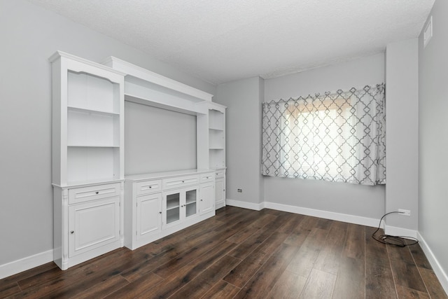 4739 W 105th St Unit 101, Oak Lawn, IL 60453 - unfurnished bedroom with dark wood-type flooring, a textured ceiling, and baseboards