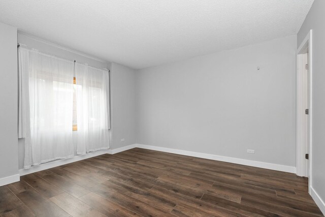 4739 W 105th St Unit 101, Oak Lawn, IL 60453 - unfurnished room with dark wood-style floors, baseboards, and a textured ceiling