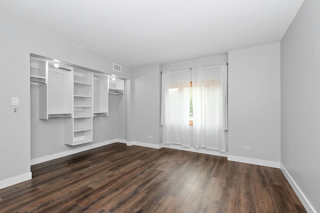 4739 W 105th St Unit 101, Oak Lawn, IL 60453 - unfurnished bedroom with dark wood-style floors, a textured ceiling, baseboards, and a closet