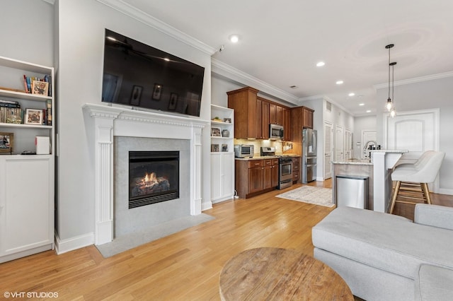 4141 N Kedzie Ave Unit 204, Chicago, IL 60618 - living area featuring light wood-style flooring, ornamental molding, recessed lighting, and a fireplace with flush hearth