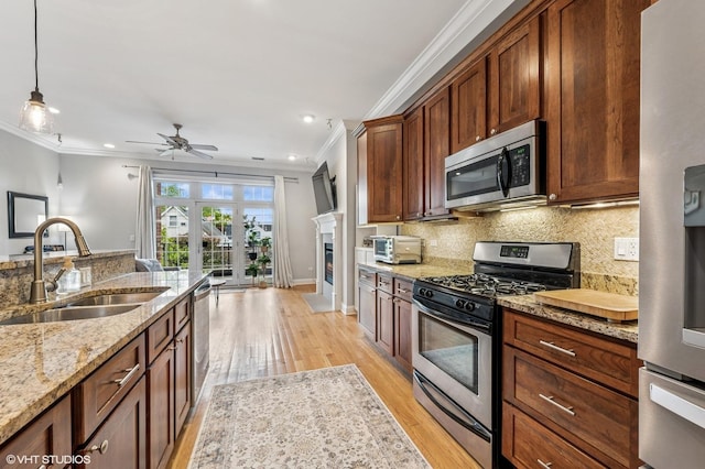 4141 N Kedzie Ave Unit 204, Chicago, IL 60618 - kitchen with stainless steel appliances, a sink, crown molding, decorative backsplash, and light wood-style floors