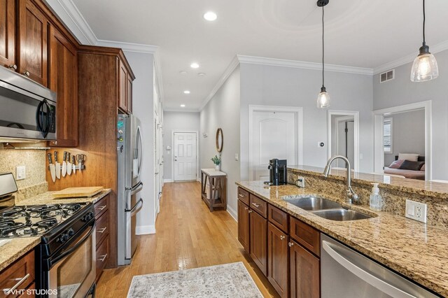 4141 N Kedzie Ave Unit 204, Chicago, IL 60618 - kitchen with appliances with stainless steel finishes, a sink, light wood finished floors, decorative light fixtures, and backsplash