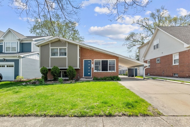 701 N Kaspar Ave, Arlington Heights, IL 60004 - view of front of home with brick siding, concrete driveway, a front lawn, and an attached carport