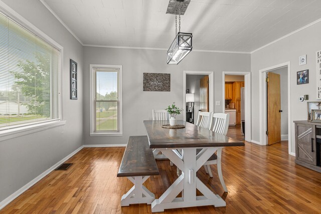 207 N E Ave, Ogden, IL 61859 - dining space with wood finished floors, crown molding, and baseboards