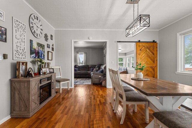 207 N E Ave, Ogden, IL 61859 - dining area with a barn door, hardwood / wood-style floors, ornamental molding, and baseboards