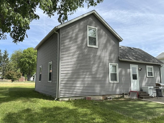 25 W Main St, Amboy, IL 61310 - back of house featuring a yard, entry steps, and roof with shingles