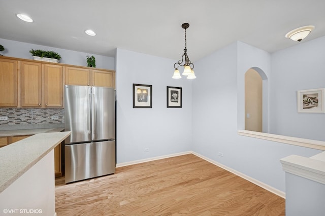1736 Francis Dr, Pingree Grove, IL 60140 - kitchen featuring freestanding refrigerator, light wood-type flooring, tasteful backsplash, baseboards, and hanging light fixtures