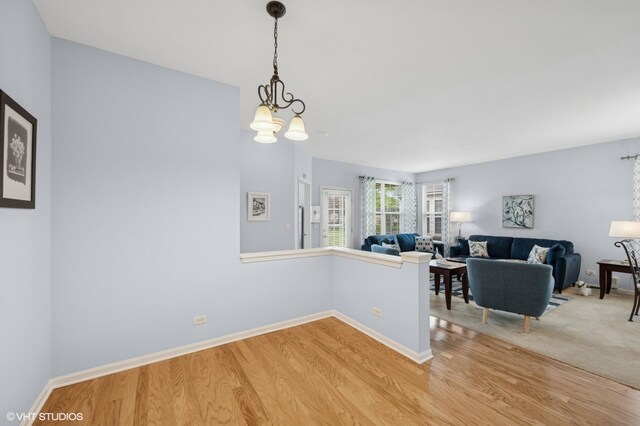 1736 Francis Dr, Pingree Grove, IL 60140 - living room with light wood-style floors, a chandelier, and baseboards