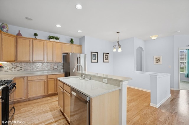 1736 Francis Dr, Pingree Grove, IL 60140 - kitchen with stainless steel appliances, a sink, light wood-type flooring, decorative backsplash, and pendant lighting