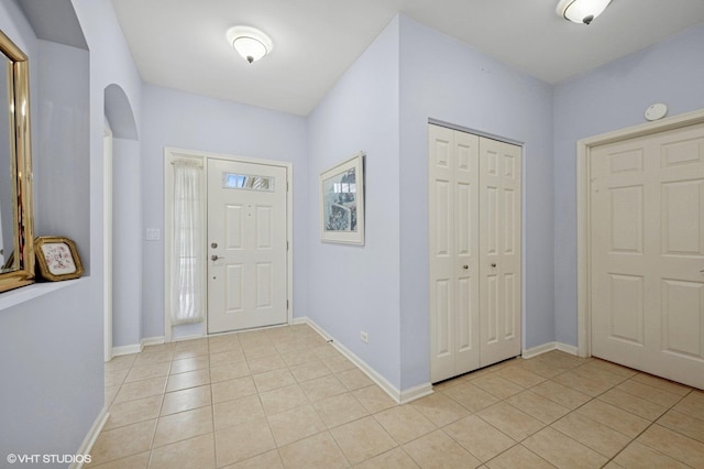 1736 Francis Dr, Pingree Grove, IL 60140 - foyer with light tile patterned floors, arched walkways, and baseboards