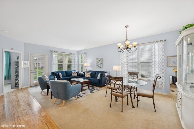 1736 Francis Dr, Pingree Grove, IL 60140 - living room with healthy amount of natural light, a chandelier, baseboards, and light colored carpet