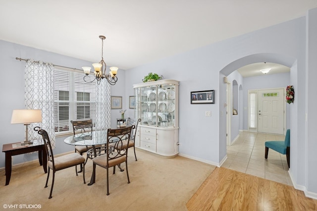 1736 Francis Dr, Pingree Grove, IL 60140 - dining space with arched walkways, a chandelier, and baseboards
