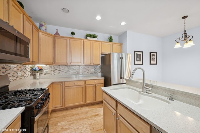 1736 Francis Dr, Pingree Grove, IL 60140 - kitchen featuring stainless steel appliances, a sink, decorative backsplash, light wood finished floors, and pendant lighting