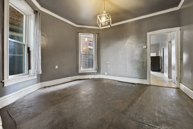 4321 W Maypole Ave, Chicago, IL 60624 - unfurnished room featuring crown molding, a chandelier, baseboards, and wood finished floors